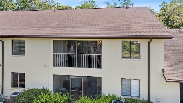 3600 Magnolia Ridge Cir Unit 1221-G, Palm Harbor, FL 34684 - rear view of property with cooling unit and stucco siding