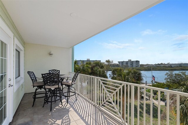 399 2nd St Unit 313, Indian Rocks Beach, FL 33785 - balcony featuring a water view and outdoor dining space