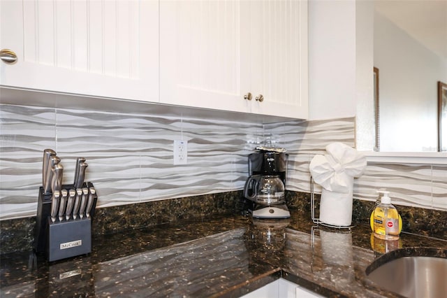 399 2nd St Unit 313, Indian Rocks Beach, FL 33785 - room details featuring white cabinetry, tasteful backsplash, and dark stone countertops