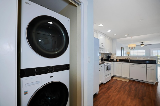 399 2nd St Unit 313, Indian Rocks Beach, FL 33785 - laundry room with laundry area, dark wood-type flooring, recessed lighting, ceiling fan, and stacked washer and clothes dryer
