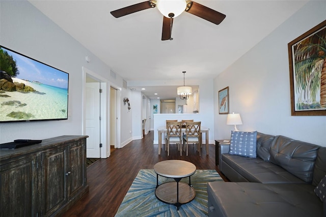 399 2nd St Unit 313, Indian Rocks Beach, FL 33785 - living room with baseboards, wood finished floors, and ceiling fan with notable chandelier