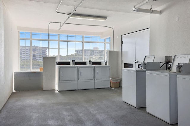 399 2nd St Unit 313, Indian Rocks Beach, FL 33785 - community laundry room with a city view, a wealth of natural light, and independent washer and dryer