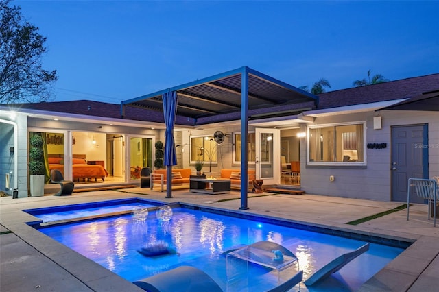 back of house with outdoor lounge area, a pool with connected hot tub, and a patio area