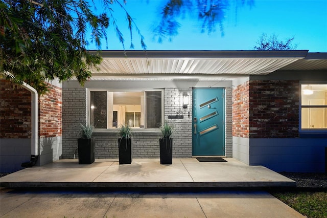 entrance to property with brick siding