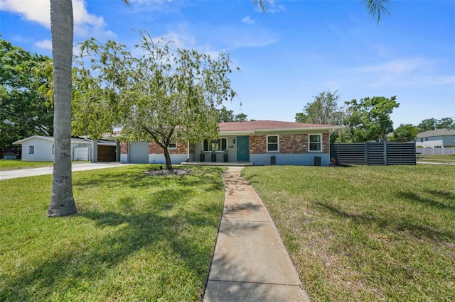 single story home with fence, driveway, a front yard, and brick siding