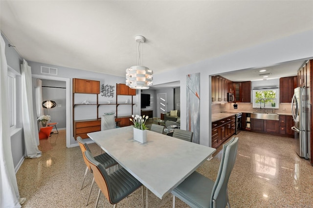 dining room featuring baseboards and visible vents