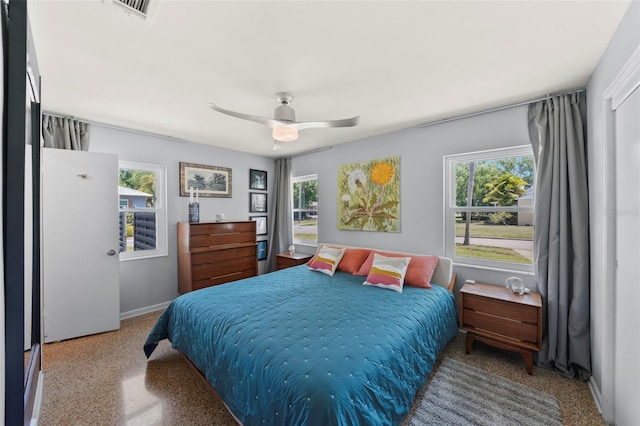 bedroom featuring visible vents, ceiling fan, baseboards, and multiple windows