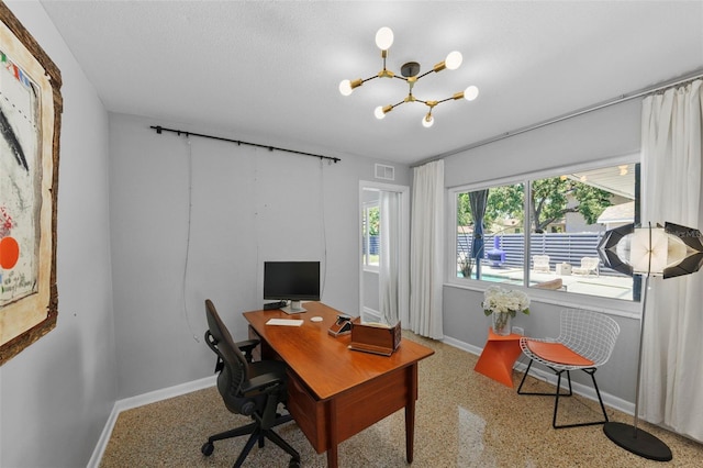 home office featuring baseboards, visible vents, a chandelier, and speckled floor