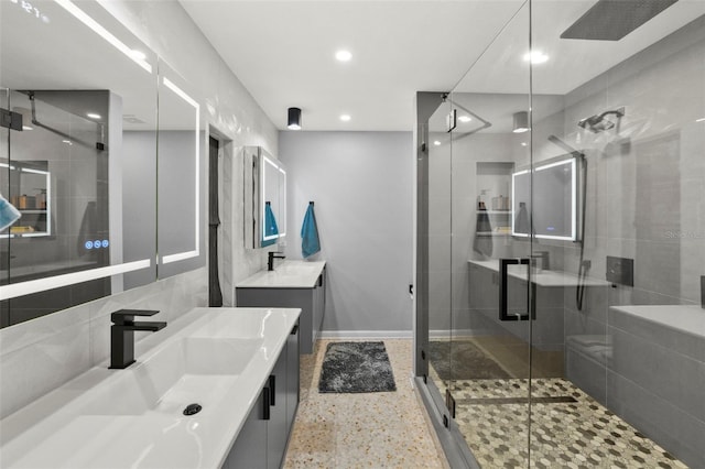 bathroom featuring recessed lighting, vanity, a stall shower, baseboards, and speckled floor