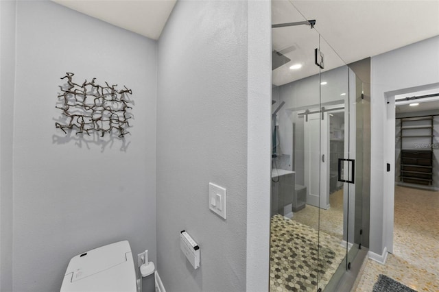 bathroom with baseboards, recessed lighting, a stall shower, and toilet