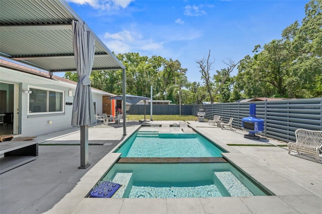 view of swimming pool featuring a patio, a fenced in pool, a fenced backyard, and an in ground hot tub
