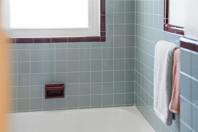 full bath featuring a healthy amount of sunlight and  shower combination