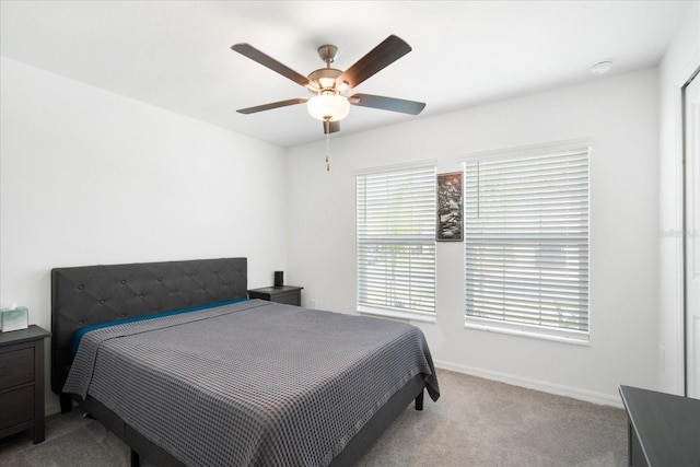 bedroom with ceiling fan, carpet, and baseboards