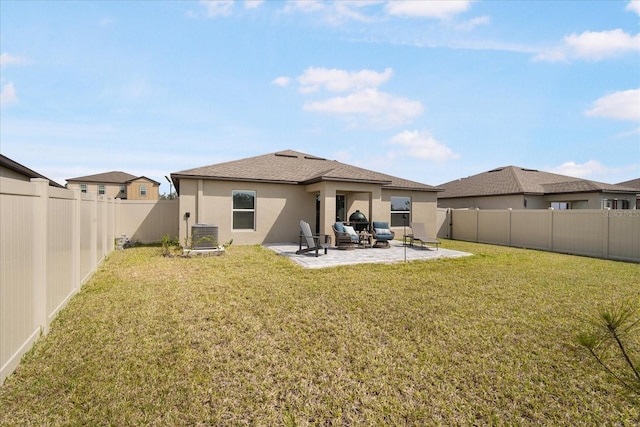 rear view of property with central AC unit, a patio area, a yard, a fenced backyard, and stucco siding