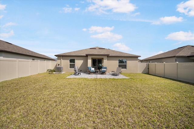 rear view of house with a patio area, a fenced backyard, cooling unit, a lawn, and stucco siding