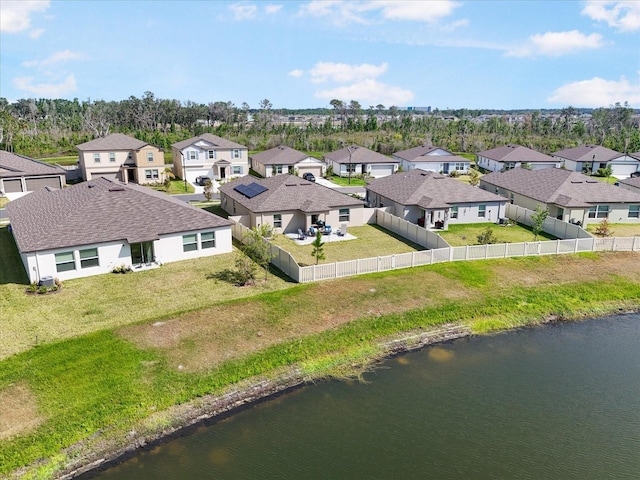 birds eye view of property with a water view and a residential view