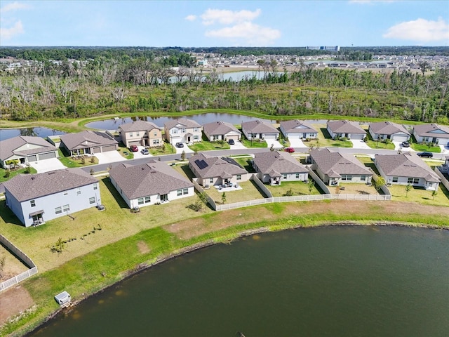 drone / aerial view featuring a water view and a residential view