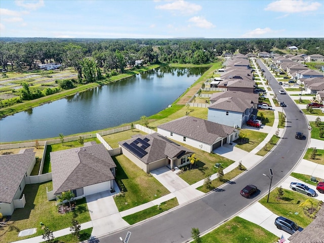 drone / aerial view with a residential view and a water view