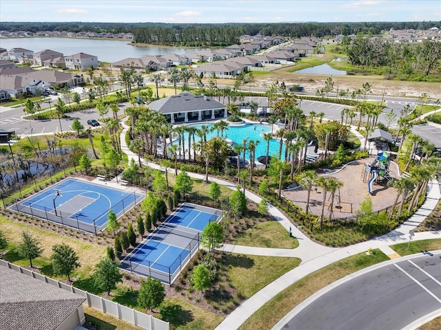 drone / aerial view featuring a residential view and a water view