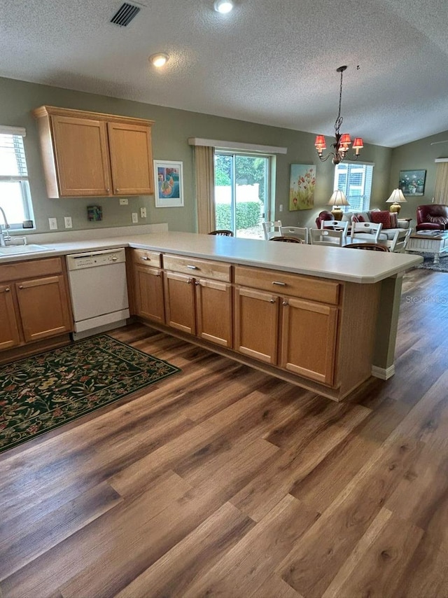 kitchen with a sink, a textured ceiling, dishwasher, and visible vents