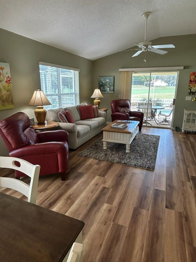 living room with wood finished floors, ceiling fan, a textured ceiling, and lofted ceiling