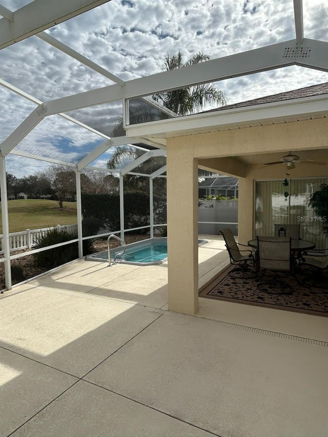 view of pool featuring fence, glass enclosure, a fenced in pool, and a patio area