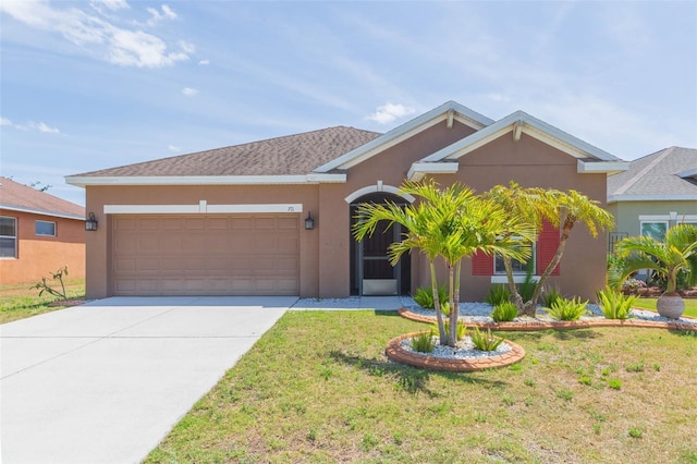 view of front of home featuring an attached garage, a front yard, stucco siding, and driveway