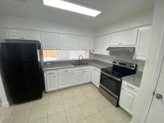 13909 Fletchers Mill Dr, Tampa, FL 33613 - kitchen featuring freestanding refrigerator, stainless steel range with electric stovetop, a sink, and white cabinetry