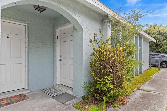 entrance to property with stucco siding