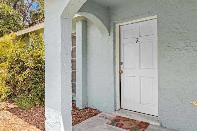 doorway to property with stucco siding