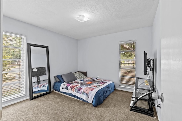 carpeted bedroom featuring a textured ceiling