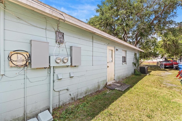 view of home's exterior featuring central AC and a yard