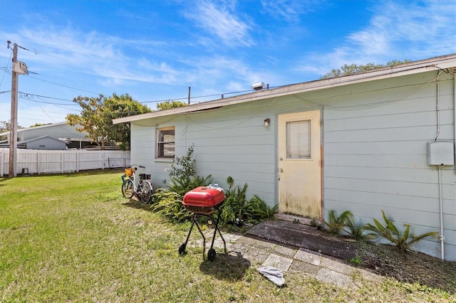 back of house with a yard and fence