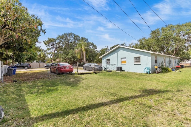 view of yard featuring cooling unit and fence