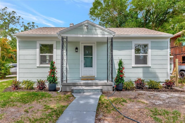 1419 55th St S, Gulfport, FL 33707 - bungalow-style house with roof with shingles and a porch