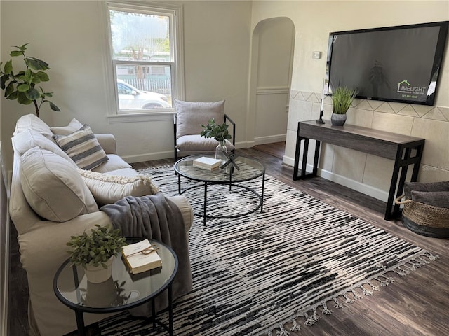 1419 55th St S, Gulfport, FL 33707 - living room featuring arched walkways, wood finished floors, and baseboards