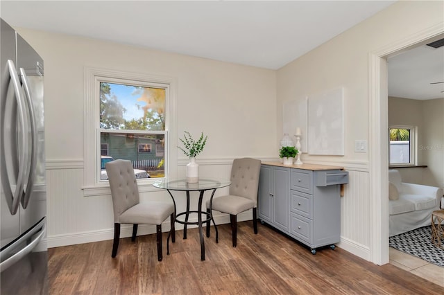 1419 55th St S, Gulfport, FL 33707 - dining area with wood finished floors, wainscoting, and baseboards