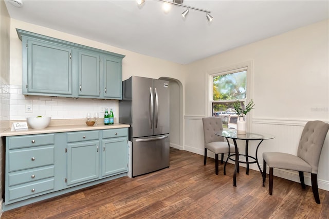 1419 55th St S, Gulfport, FL 33707 - kitchen with freestanding refrigerator, dark wood-style floors, blue cabinets, light countertops, and tasteful backsplash