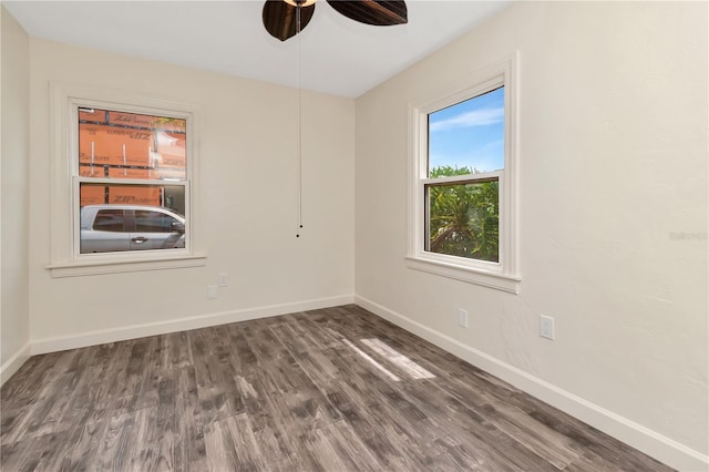 1419 55th St S, Gulfport, FL 33707 - empty room featuring wood finished floors, baseboards, and ceiling fan
