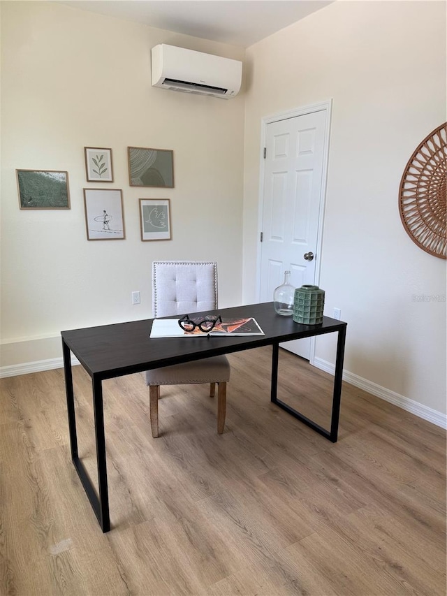 1419 55th St S, Gulfport, FL 33707 - office featuring a wall mounted AC, light wood-style flooring, and baseboards