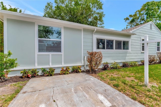 1419 55th St S, Gulfport, FL 33707 - view of side of property with a patio area