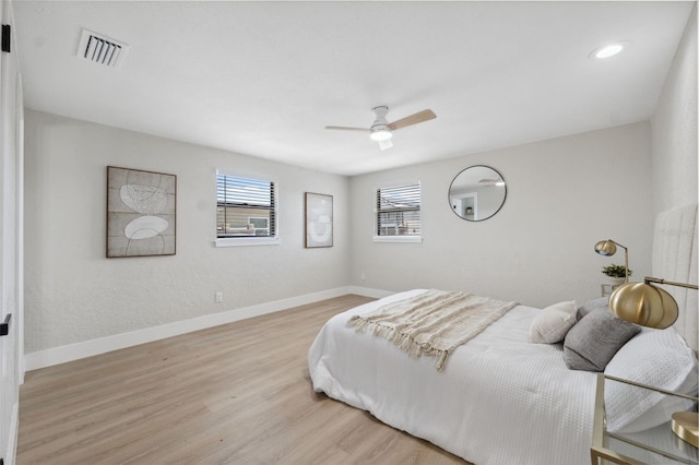13810 Malcolm Ave, Hudson, FL 34667 - bedroom with multiple windows, baseboards, and light wood-type flooring