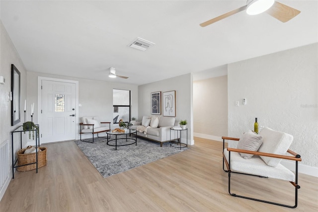 13810 Malcolm Ave, Hudson, FL 34667 - living area featuring ceiling fan, wood finished floors, and baseboards