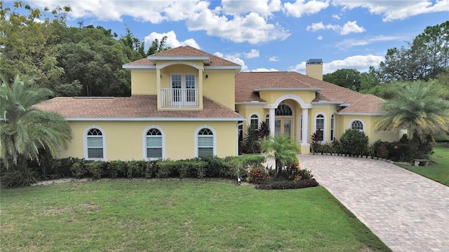 1312 Fishing Lake Dr, Odessa, FL 33556 - mediterranean / spanish-style home featuring a front lawn, a chimney, french doors, and stucco siding