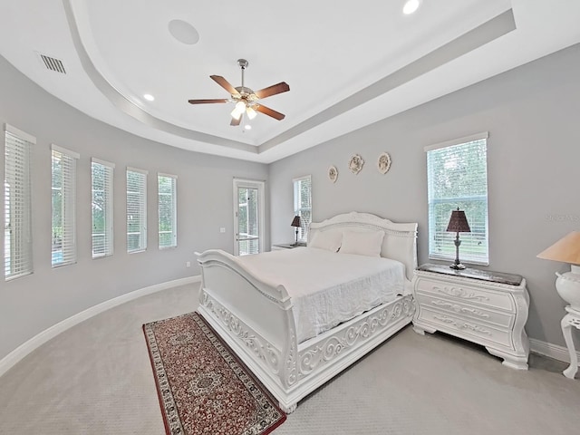 1312 Fishing Lake Dr, Odessa, FL 33556 - bedroom with light carpet, a tray ceiling, visible vents, and baseboards