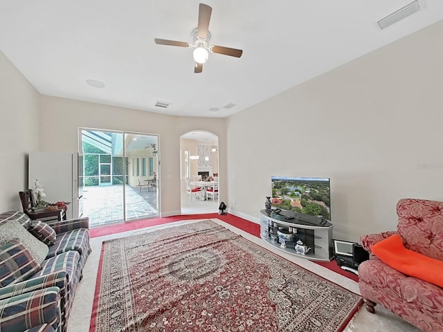 1312 Fishing Lake Dr, Odessa, FL 33556 - living area featuring arched walkways, baseboards, carpet, visible vents, and ceiling fan