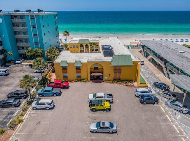 drone / aerial view featuring a water view and a view of the beach