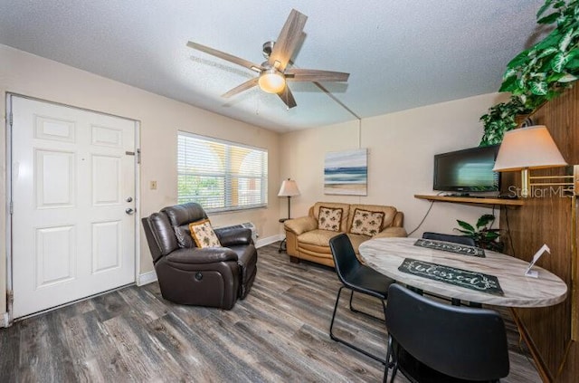 living room with baseboards, a ceiling fan, and wood finished floors