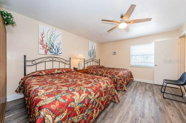 bedroom featuring baseboards, a ceiling fan, and wood finished floors