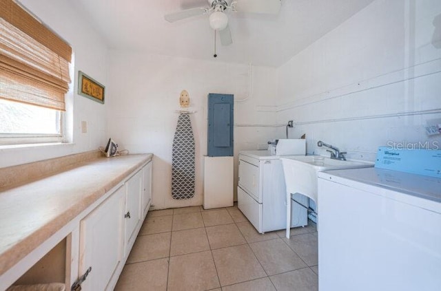 washroom with cabinet space, light tile patterned flooring, ceiling fan, separate washer and dryer, and electric panel